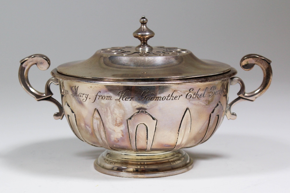 A Victorian silver circular two-handled porringer and cover, the lid and sides with cut card work,