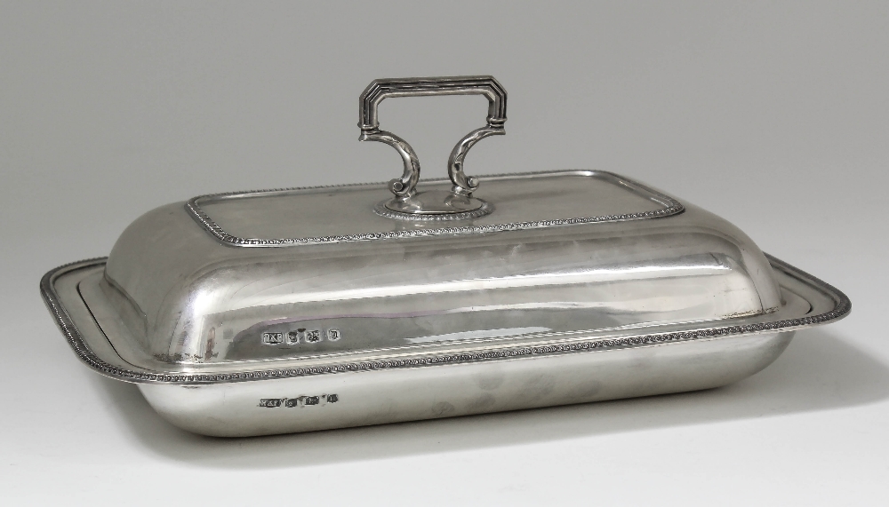 A George V silver rectangular entree dish and cover with bead mounts and angular finial, 10.75ins