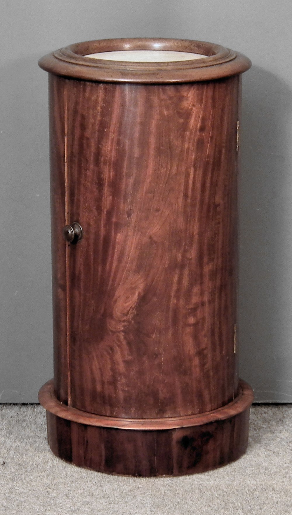 A Victorian mahogany cylindrical bedside cupboard, the top inset with white veined marble slab,