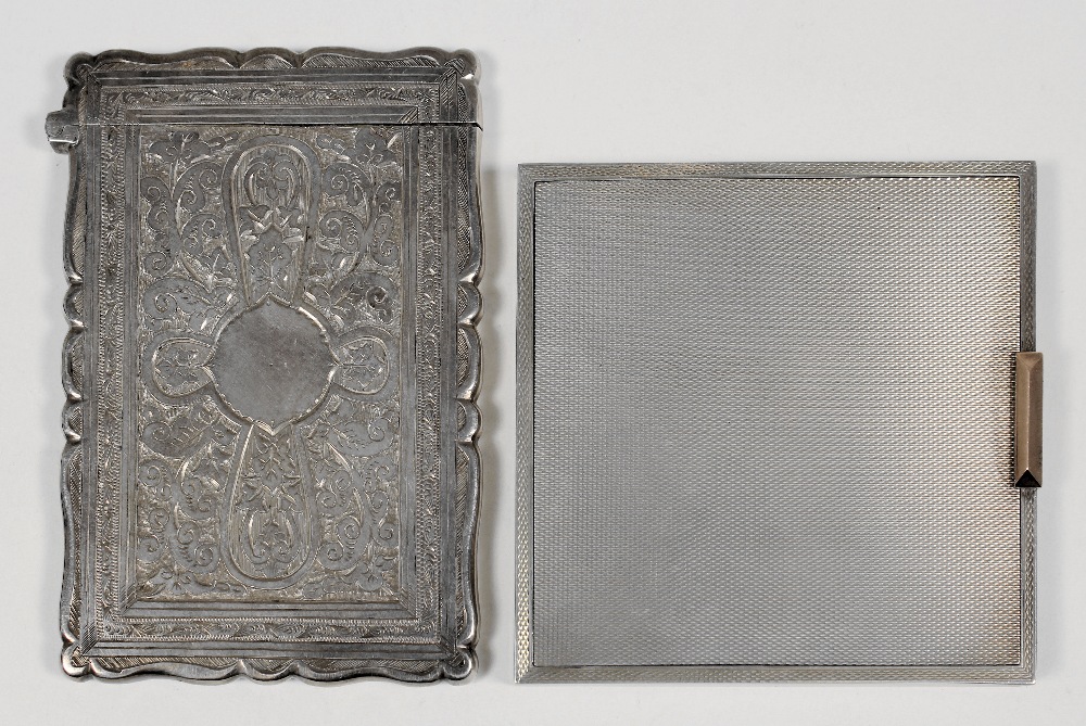 A Victorian silver card case of shaped outline, the whole engraved with circular cartouche, leaf and