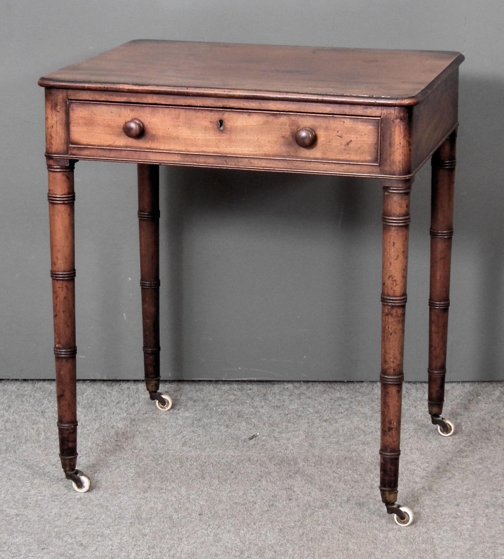 A late Georgian mahogany rectangular occasional table, the top with rounded corners, fitted single