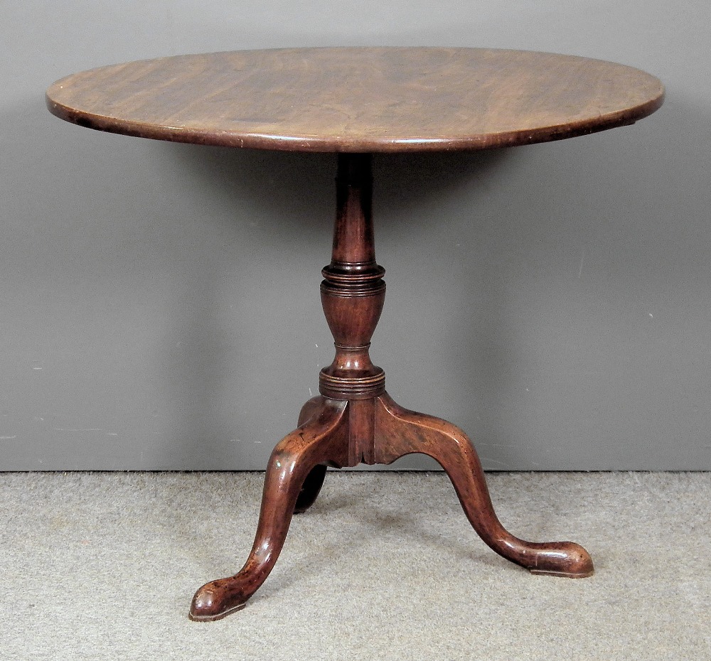 A George III mahogany circular tripod table with plain one piece top on turned column and cabriole