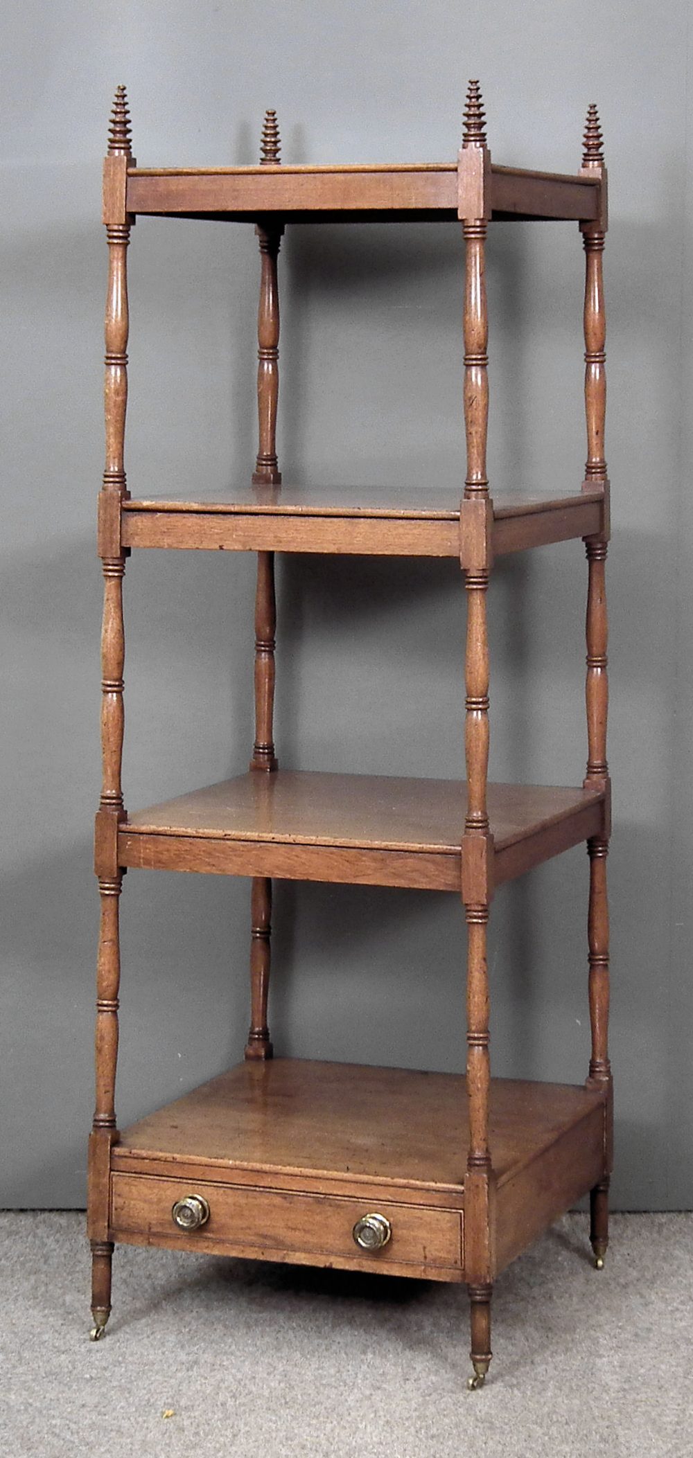 A late George III mahogany square four tier whatnot on turned supports, the base fitted single