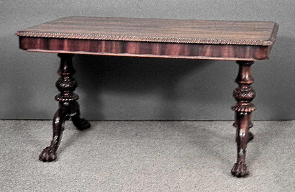 A Victorian rosewood rectangular centre/library table, the top with gadrooned edge, fitted two