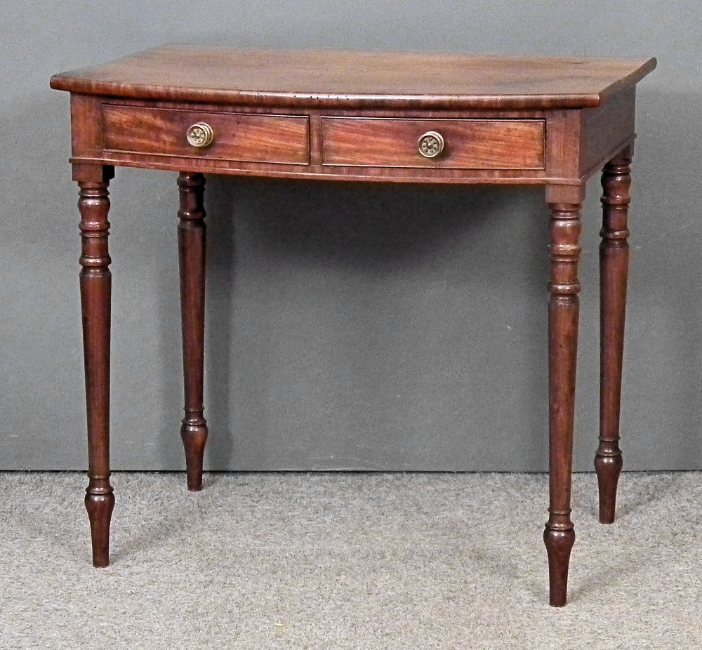 A late Georgian mahogany bow-front side table fitted two drawers, on turned legs, 32ins wide x 21ins