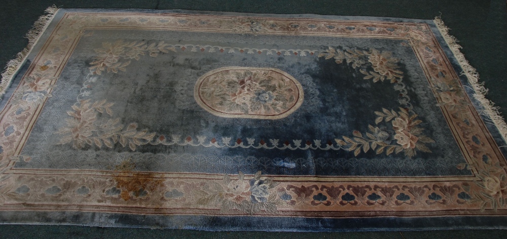 SUPER WASHED CHINESE SMALL CARPET with off-white and floral centre oval medallion on a pale blue