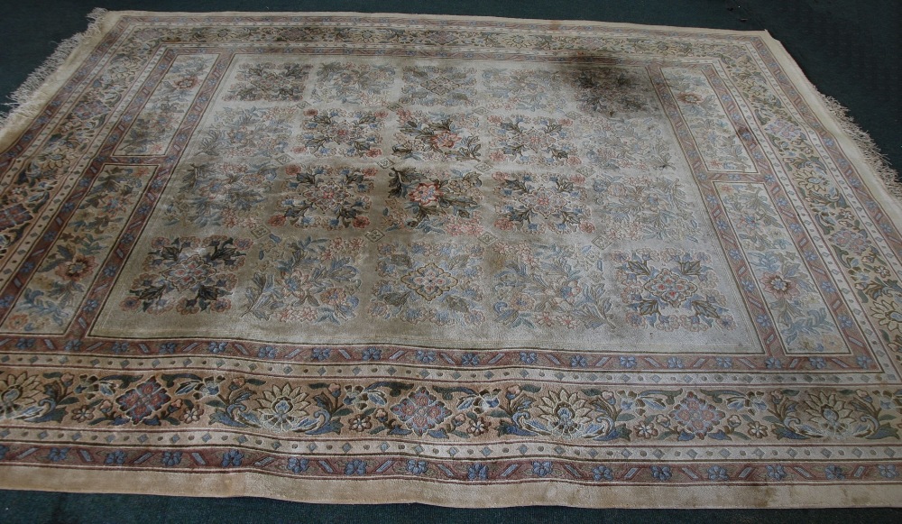 `KAYAM` WASHED CHINESE CARPET with all-over floral tiles pattern on a grey field with two floral