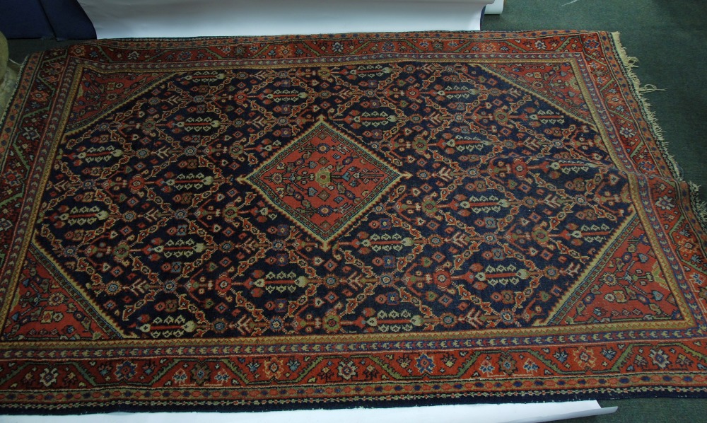 SHIRAZ PERSIAN RUG with red and floral diamond shaped centre medallion and spandrels on a midnight