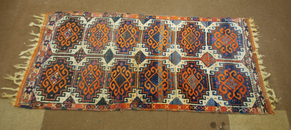 TURKISH BERGAMA RUG, with two rows of six tile pattern medallions with orange red hooked design on