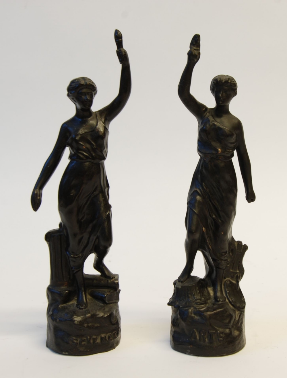 PAIR OF BLACK PAINTED SPELTER FEMALE FIGURES, `SCIENCE` and `ARTS` both modelled standing with one