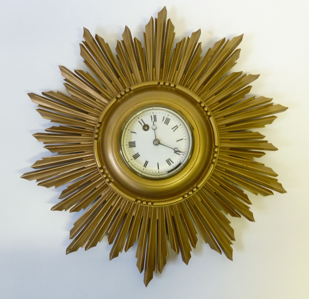 GILTWOOD SUNBURST WALL CLOCK WITH 8 days movement winding through the white enamelled roman dial