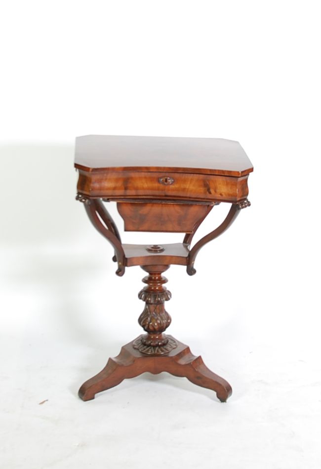 EARLY NINETEENTH CENTURY FIGURED AND CARVED MAHOGANY PEDESTAL WORK TABLE, the frame cut, canted