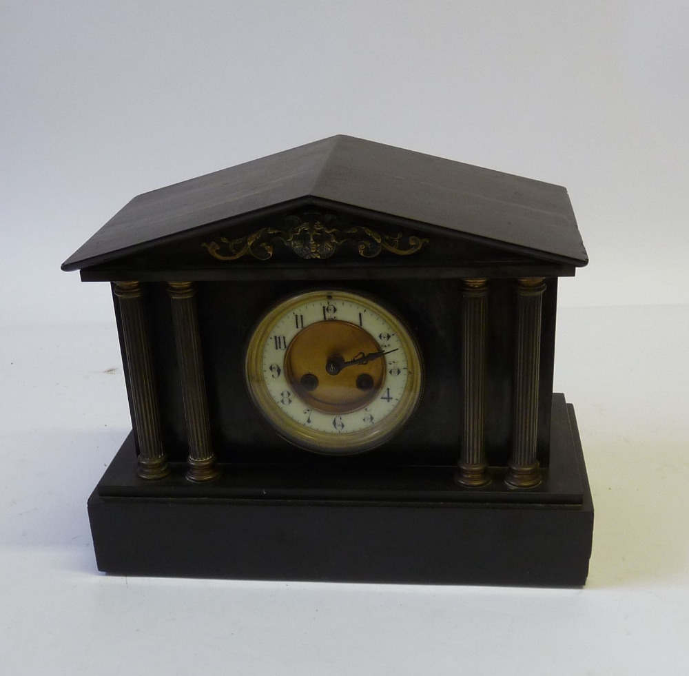 A VICTORIAN BLACK SLATE AND GILT METAL MANTLE CLOCK, the 3 ¾" (9.5cm) dial, with white roman chapter