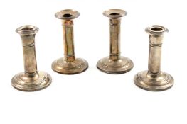 Two pairs of silver column candlesticks, one pair hallmarked Birmingham 1905 and with makers mark: