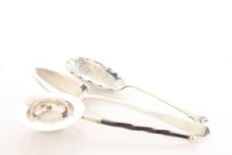 Two silver spoons and a tea strainer:  A Georgian silver table spoon, An Edwardian silver spoon,