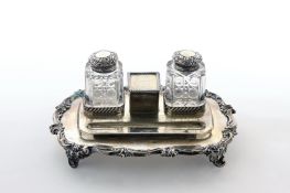 A Victorian silver ink stand, hallmarked Sheffield 1895, with twin cut glass inkwells with
