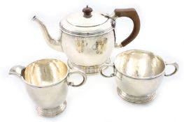 A George V hammered silver three piece tea set, hallmarked London 1928, of good quality and globular