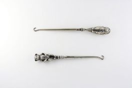 Two Edwardian silver handled button hooks, the first formed as a two-sided teddy bear and hallmarked