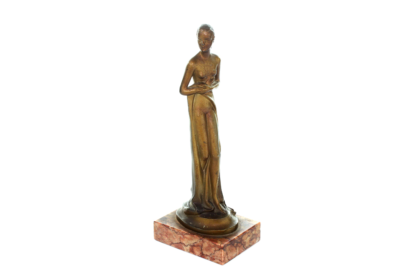 An Art Nouveau spelter nude woman table lighter, formed as a partially nude woman with robe around