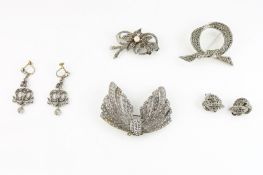 An Art Deco style Continental silver wing shaped brooch, set marcasite together with another