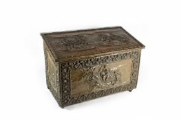 A copper plated log bin, with sloping lid and embossed front and side panels of medieval scenes