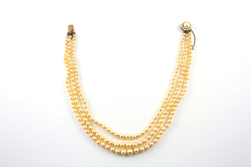 A three row cultured pearl necklace on 9ct gold snap clasp set with graduated cultured pearls,
