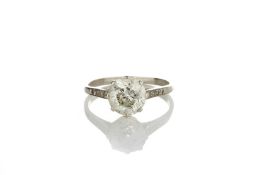 A single stone diamond ring of approximately 3 carats, in claw setting with diamond shoulders,