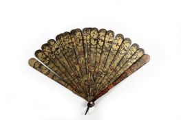 A Chinese lacquer wooden fan, probably 19th cntury, with wooden guard sticks decorated on the