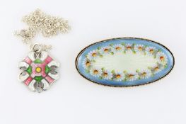 A Continental silver oval shaped brooch with engine turned enamel decoration in blue, white and