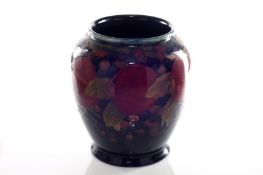 A Moorcroft Pomegranate vase, circa 1925, decorated on a deep blue ground, with impressed mark to