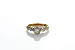 An 18ct gold and platinum set single stone diamond ring, with leaf shaped shoulders, in closed