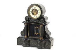 A Victorian black slate mantel clock, the drum top with white enamel dial and open centre showing