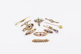 A collection of eleven gem set Edwardian brooches and pins, comprising of seven gold bar brooches