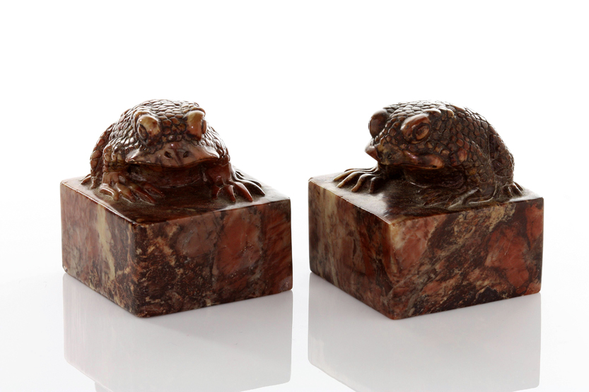 A pair of Japanese carved soapstone toad seals, formed as toads seated on square seal block bases,