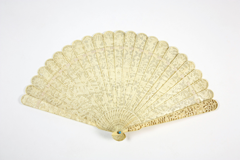 An early 19th century Chinese carved ivory fan, with carving to outer guard sticks front and back