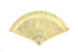 A very finely carved and pierced ivory fan Chinese, early 19th century, the ivory sticks pierced