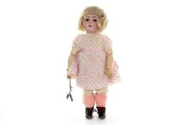 An unusual German bisque headed roller skating doll, early 20th century with moveable eyes and