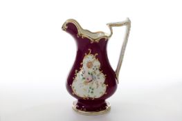 A Victorian Staffordshire porcelain puzzle jug, decorated with panels of flowers on a puce ground