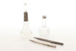 A Samson & Mordon silver propelling pencil, together with two silver topped glass scent bottles