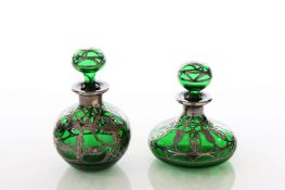 Two Art Nouveau silver overlaid green glass scent bottles, of globular and bulbous form, with