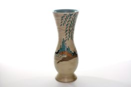 A large Clarice Cliff pottery vase, the body of slender form with flared neck and decorated with a