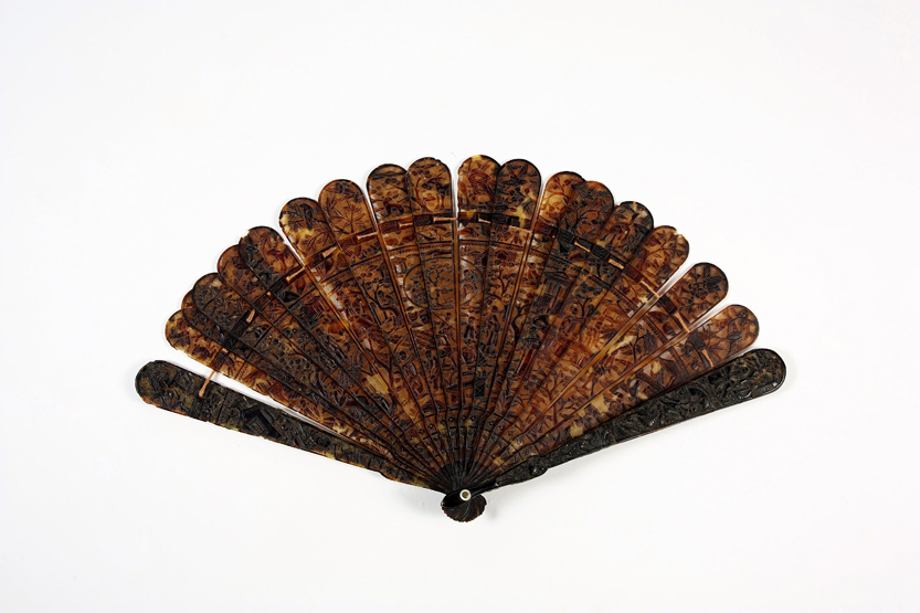 A 19th century Chinese carved tortoiseshell fan, the guard sticks finely carved with animals,