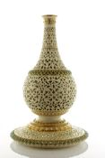 A Grainger & Co. Worcester reticulated bottle vase, dated 1892, of Persian influence decorated