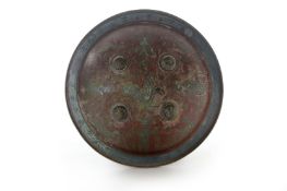 An unusual Eastern brass circular shield, of domed form, engraved with a central winged beast and