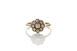 An 18ct gold diamond cluster ring, with nine old mine diamonds, in flower setting, size ‘Q’