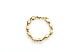 A 9ct gold opal bracelet, set with ten oval opals, with safety catch. Hallmarked for Birmingham