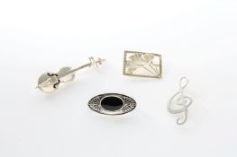 A group of four modern silver brooches, comprising a violin, treble clef, oval onyx inset brooch,