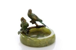 A 1930s cold painted bronze and onyx pin tray, crested with a pair of parakeets on branches and