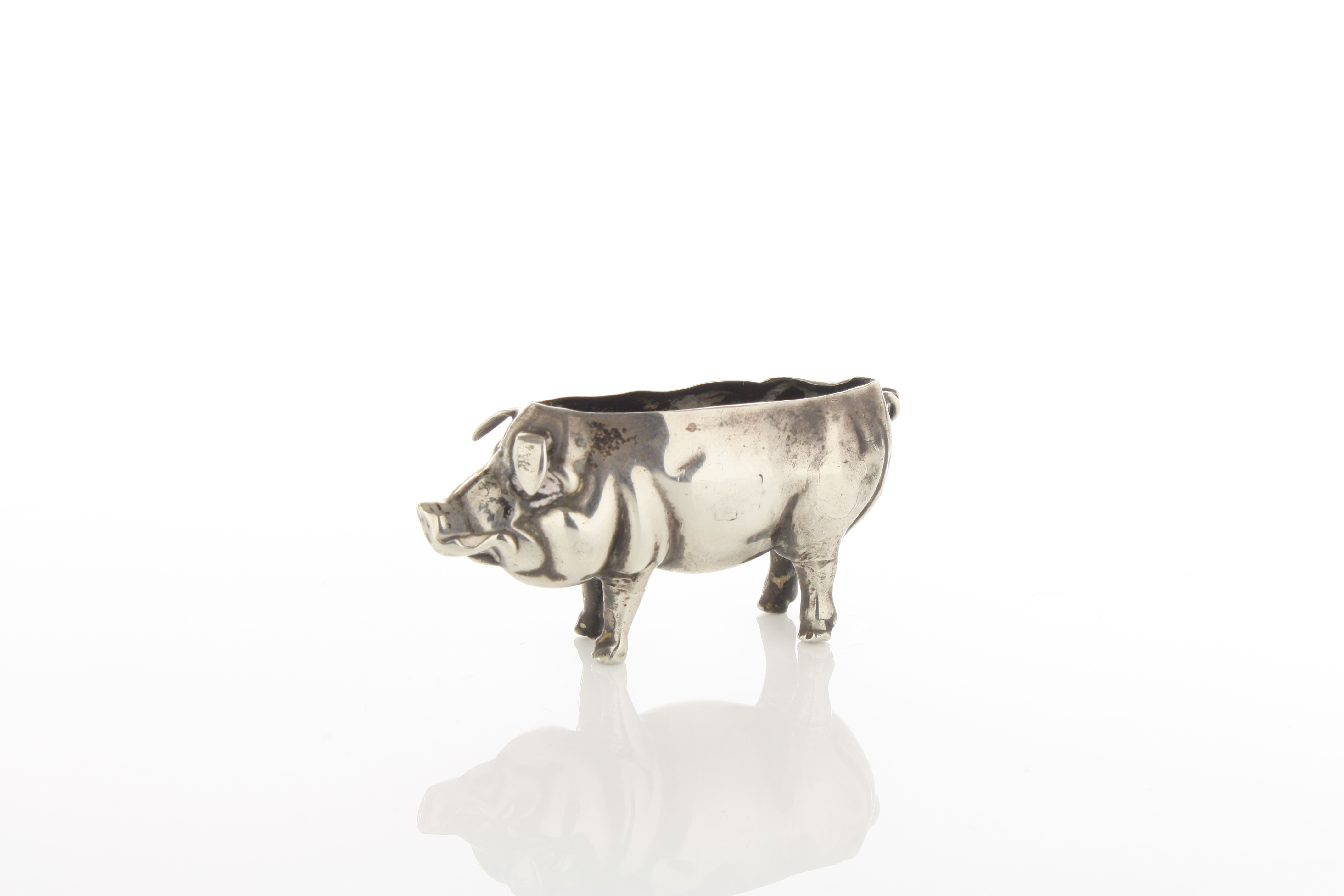 A silver pin cushion in the form of a pig, circa 1900, missing liner, rubbed mark, length 5.5cm