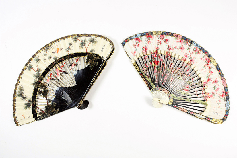 Two Japanese hand painted wooden fans, 20th century, both signed M.Eiteve, the first with cut out